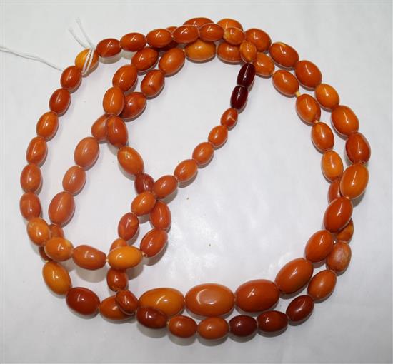 A single strand graduated oval amber bead necklace, gross weight 76 grams, 116cm.